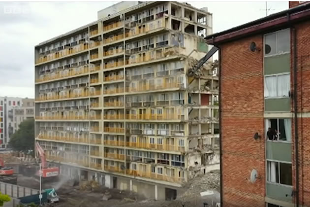 Yakob and his family look out of their window at building being demolished