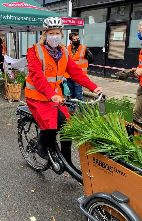 A person riding on the back of a bicycle Description automatically generated