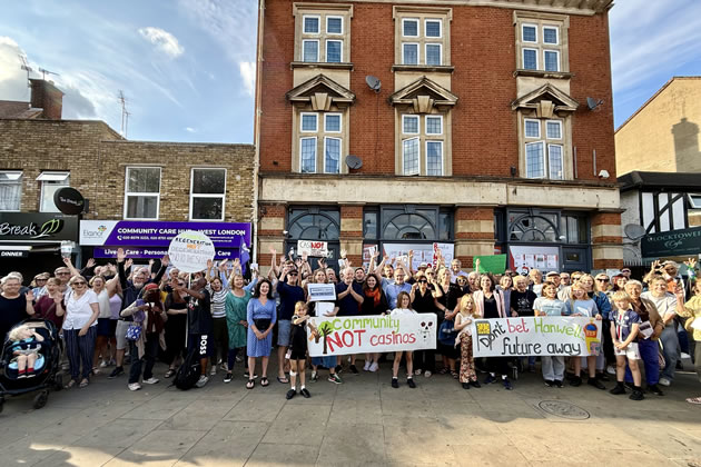 Protestors line up in front of the building where the slot casino is planned 