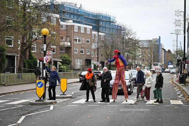 Maystar Residents&rsquo; Association committee members, including Debbie Golt (left) and Michael Gannon, MRA Co-Chair (middle) on the crossing with stilt-walker Ella the Great